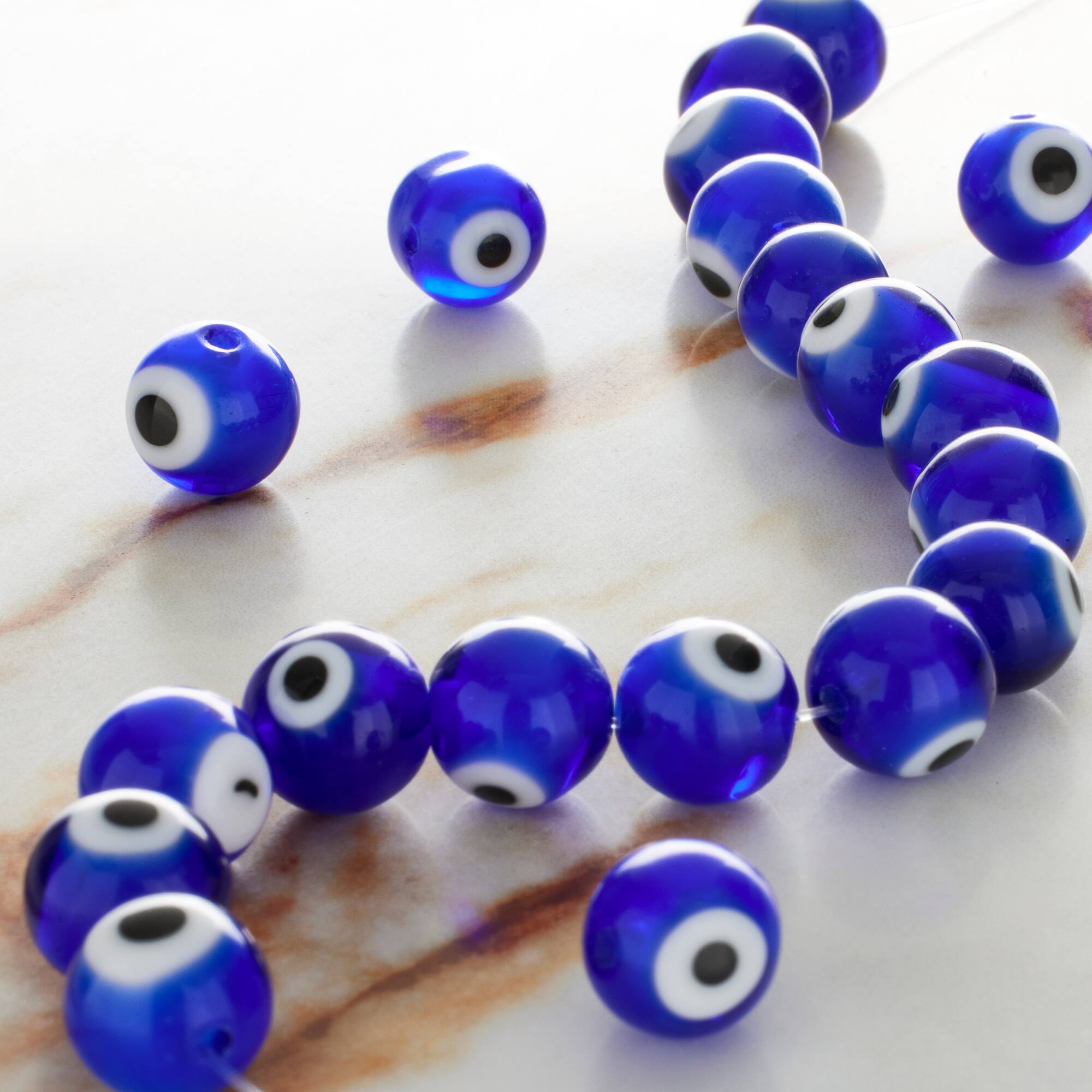 12 Pack: Blue Evil Eye Glass Round Beads by Bead Landing